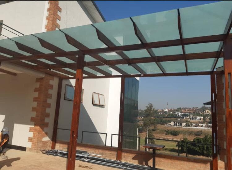 Outdoor pergola with translucent glass roof panels on a residential terrace